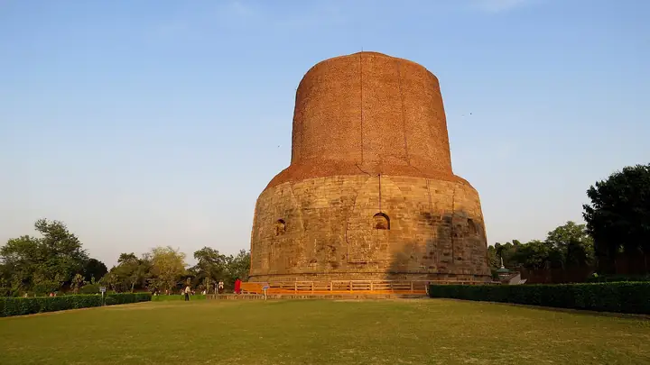 Dhamek Stupa on green lawns at Sarnath